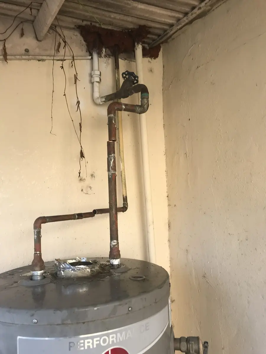 Replacement water heater set in place with the copper hot and cold lines re-run to the ceiling